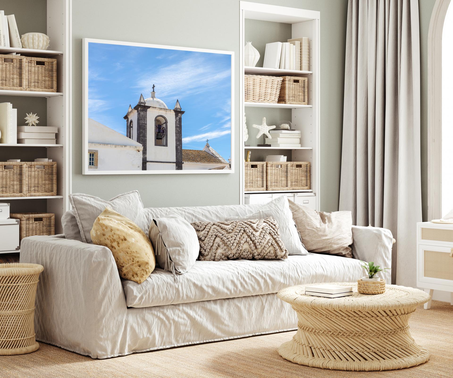 Church tower at Cacela Velha, Tavira, showing bell in tower and roof top with blue sky. Liane Ryan Photography