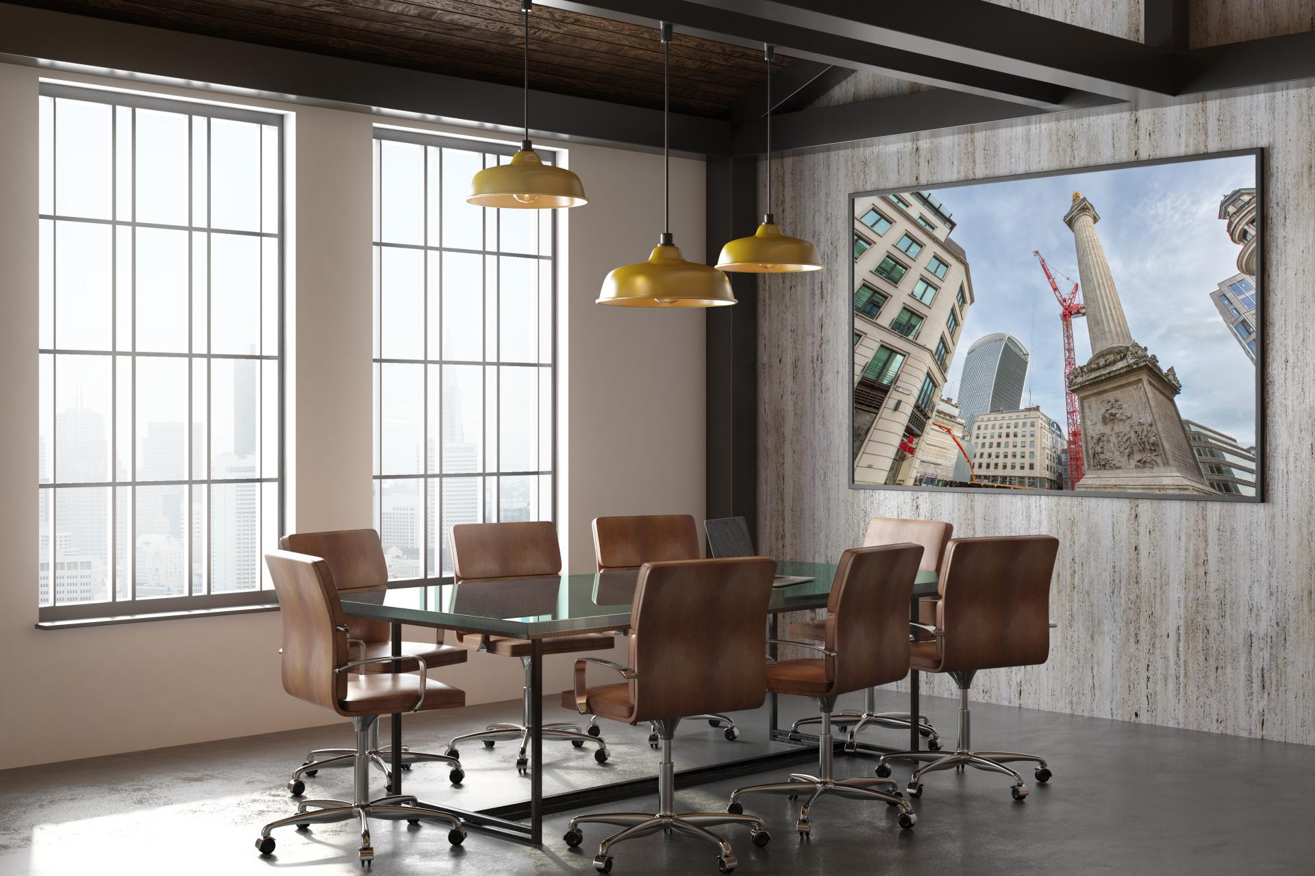 The monument london with the walkie building in the background and cranes