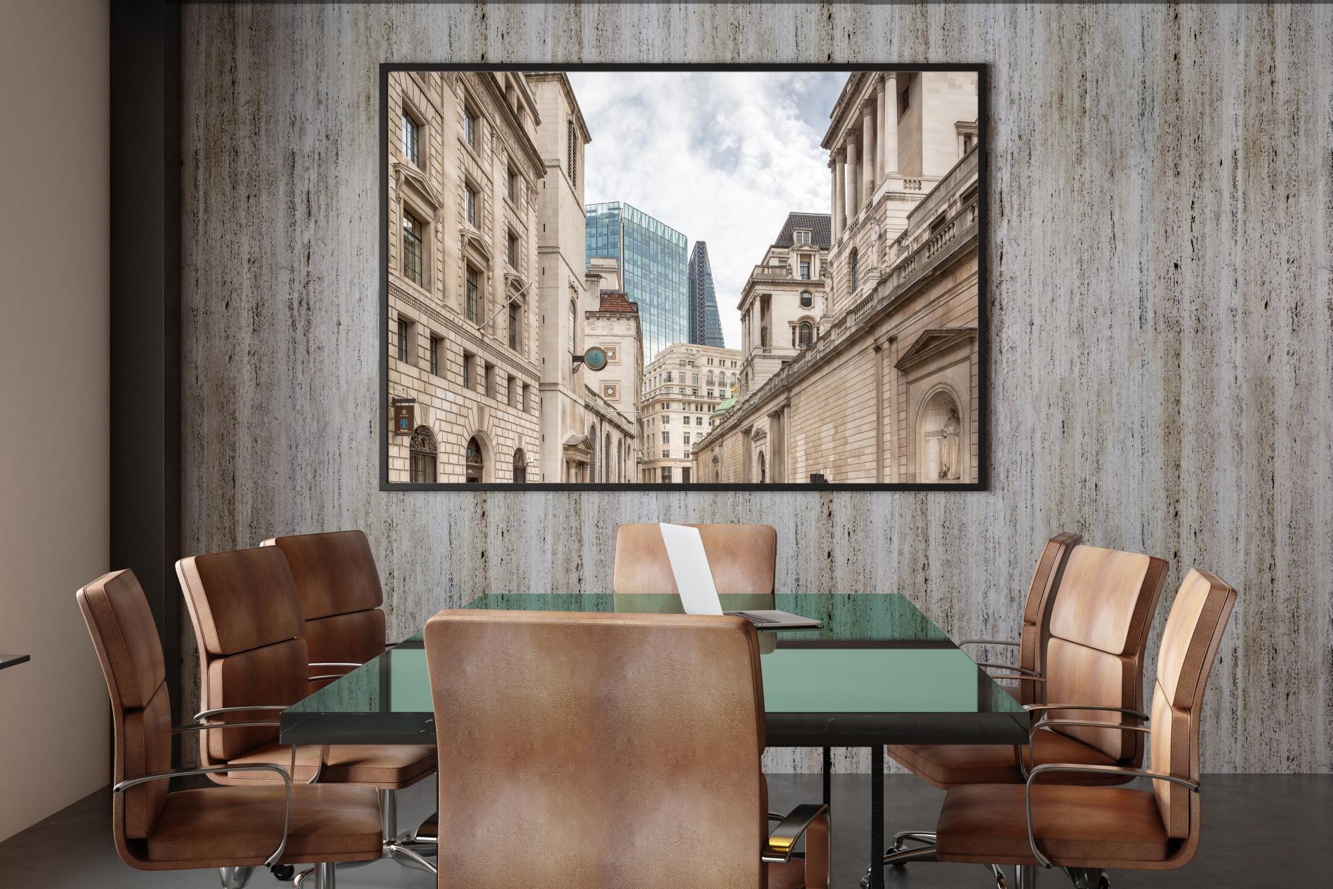Old traditional buildings in the foreground with new glass towers in the background in London showing old and new architecture.