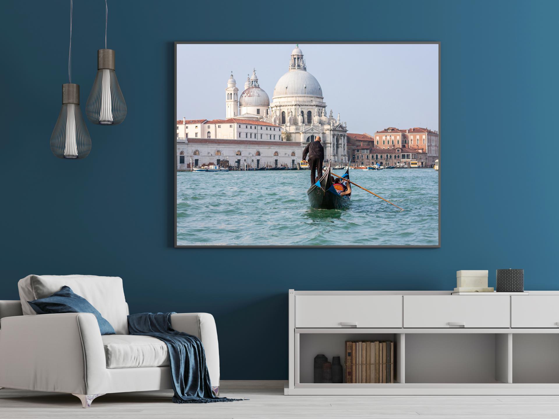 Gondola being rowed out in the water in Venice, bright colours, blue water. Liane Ryan Photography